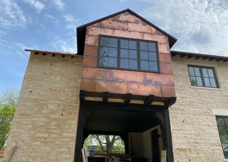 Copper metal panel facade on a stone building for Skylight Installation in Meadowbrook